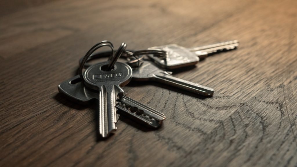 A close-up of a set of car keys on a wooden surface