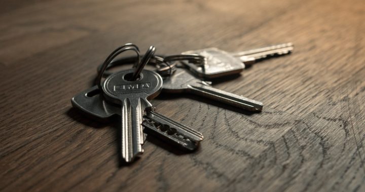 A close-up of a set of car keys on a wooden surface