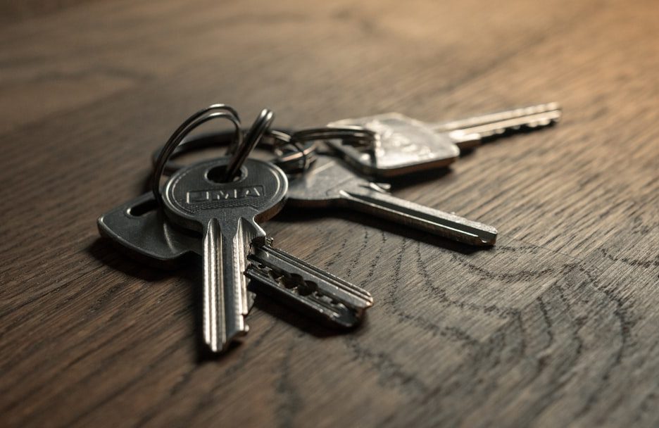 A close-up of a set of car keys on a wooden surface
